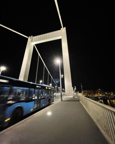 Bus Crosses Bridge at Night in Budapest